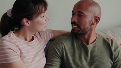 Loving Couple Talking on a Couch Together Indoors