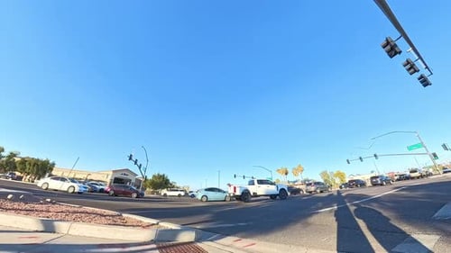 Intersection with Passing Cars on a Sunny Day