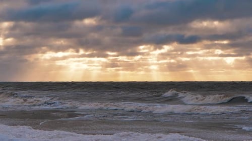 Sea storm with big waves at sunset. Strong waves on the sea coast. Selective focus