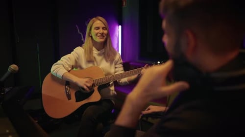 Talented Female Musician Playing Guitar for Sound Producer in Recording Studio Audition and Casting