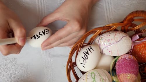 Woman Decorating Easter Eggs at Home