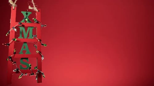 Christmas Decoration Ladder on Red Copy Space Background