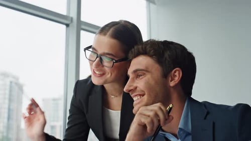 Smiling Colleagues Discussing Work in Modern Office