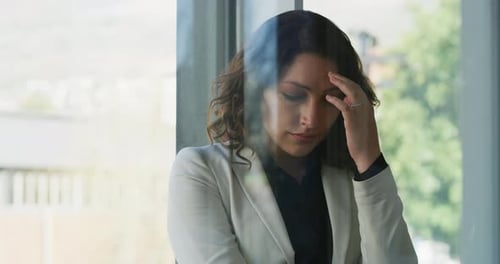 Distraught Woman in Business Blazer Looking Downcast