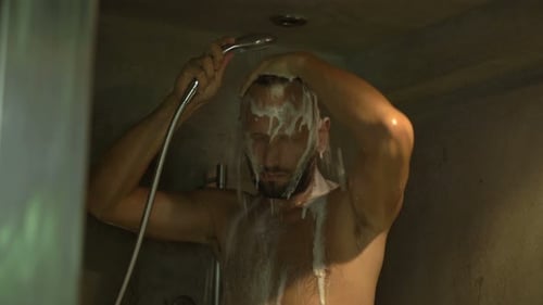 Man Wets and Washes Hair in Shower