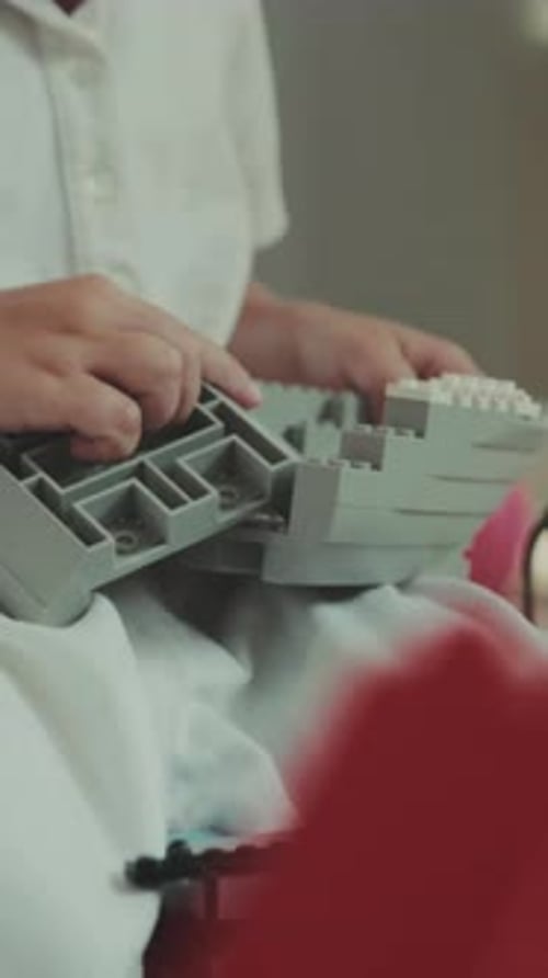 Focused Child Building with Construction Toy Indoors