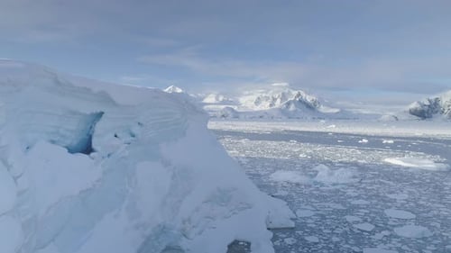 Blue Ice Cave in White Glacier on Antarctic Peninsula Aerial Shot Closeup