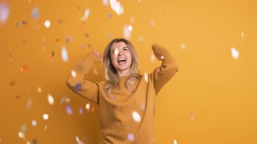 Excited Woman Celebrates with Colorful Confetti