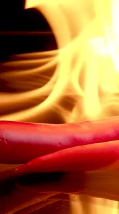 Fiery Red Chili Peppers on Reflective Surface