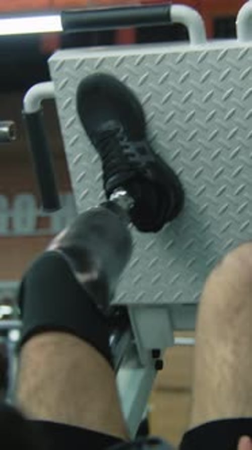 Adult Man Using Leg Press with Prosthetic Leg