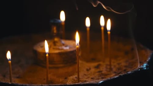 Burning Candles in Dark Setting
