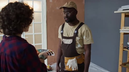 Adults Discuss Paint Color Palette Indoors