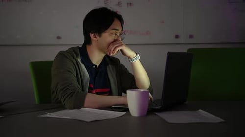 Man Working Late on Laptop in Office
