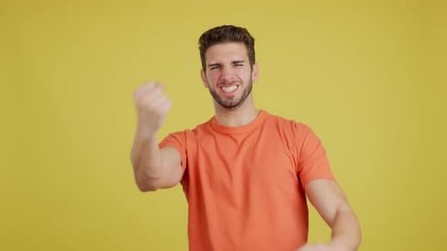 Celebrating Man Cheers with Fists Raised in Triumph