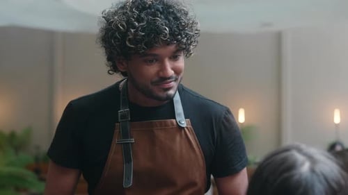 Smiling Waiter Taking Order on Tablet in Cafe