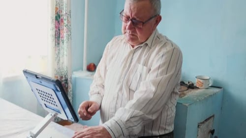 Senior Man Using a Tablet Device at Home