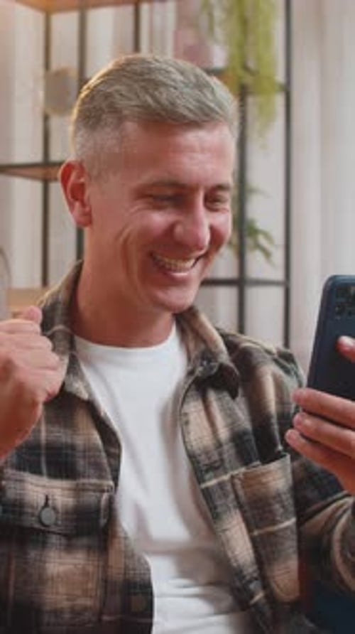 Surprised Excited Man Winner Holding Smartphone Reading Good News Amazed By Online Game Casino Win