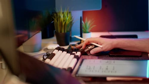 Person Works With Stylus, Tablet, and Keyboard
