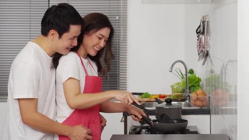 Loving Couple Cooking Together in Kitchen