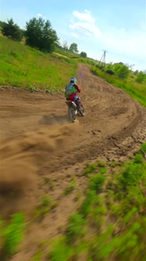 FPV Drone Chasing Racer on a Motocross Track High Speed