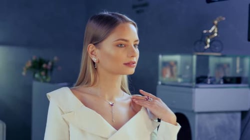 Girl is Decorated with Gold Jewelry Earrings Gold Rings in a Luxury Boutique