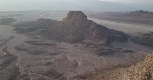 Flying over rocky desert mountains