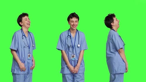 Cheerful Smiling Medical Assistant Standing Against Greenscreen Backdrop