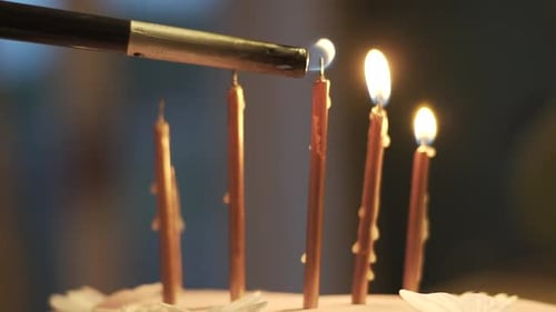 Lighting Birthday Candles on a Pink Cake