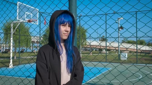 Teenager with Blue Hair Stands near Basketball Court
