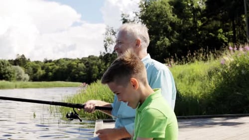 Family, Generation, Summer Holidays and People Concept - Happy Grandfather and Grandson
