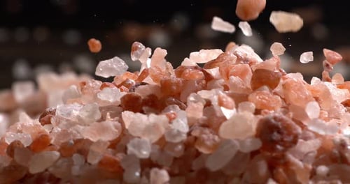 Himalayan pink salt in a super slow motion, natural mineral seasoning for healthy cooking and spa