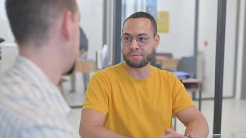 Close up of Mixed Race Man Talking with Creative Teammate