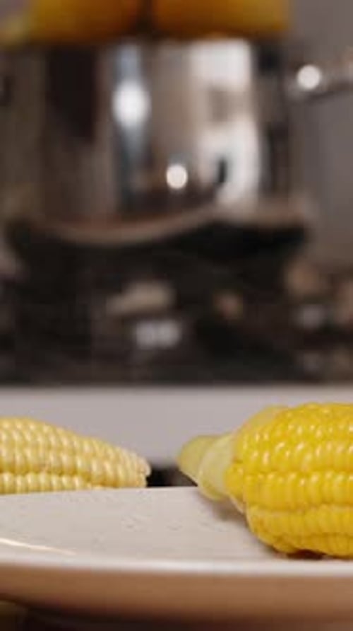 Preparing Fresh Corn on Cob in Kitchen
