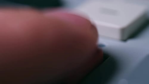 Finger Presses Orange Record Button