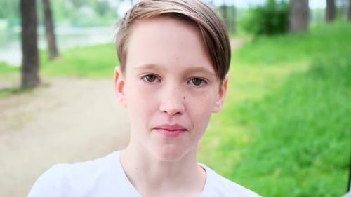 Close-up of chewing handsome boy in nature