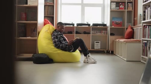 Man Enjoys Book Sitting on Soft Bean Bag
