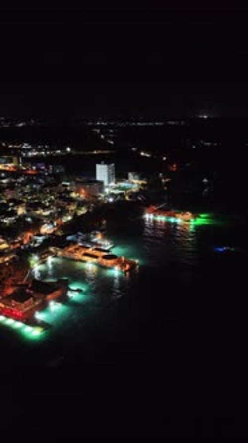 Aerial Night View Of Boca Chica Beach Restaurants, Dominican Republic, Vertical Format