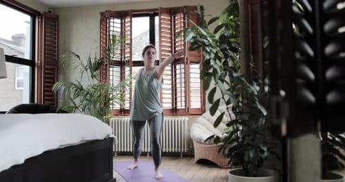 Woman Stretching on Yoga Mat at Home
