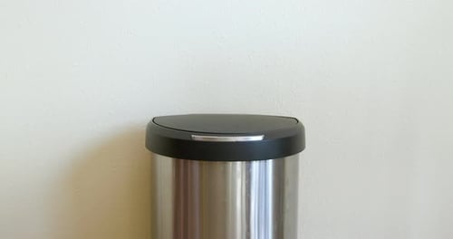 Empty Bottle Thrown in Trash Can