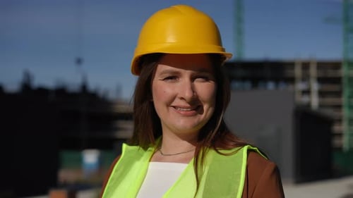 A Female Construction Worker on Site Dressed in Safety Gear Working with Confidence and Dedication