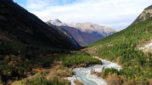 Expansive Aerial Imagery Showcasing Pristine Mountain Valley Surrounded By Colorful Fall Foliage In