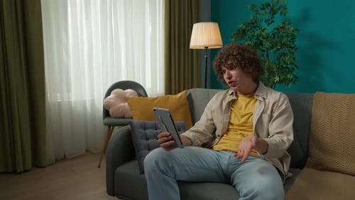 Young Adult on Tablet Video Call at Home