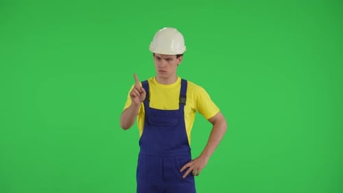 Medium Green Screen Isolated Chroma Key Video of a Young Construction Worker Swiping Tapping and