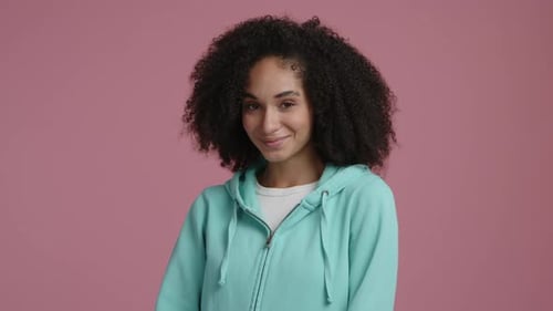 Young Woman Smiles and Winks in Studio Portrait