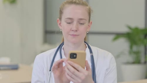 Young Doctor Uses Mobile Phone at Work