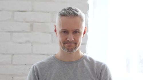 Shaking Head to No Rejecting Middle Aged Man Sitting in Office