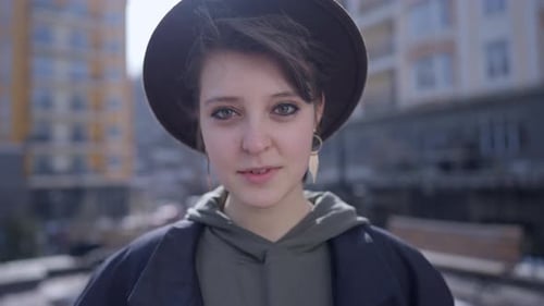Headshot Portrait of Slim Gorgeous Young Woman Looking at Camera Standing Outdoors