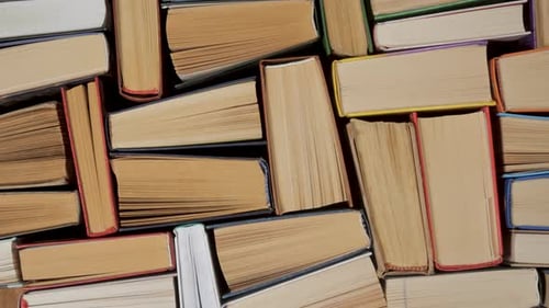Stacked Hardcover Books Viewed From Above Showing Page Edges and Bindings