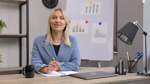 Young Woman Giving Presentation at Desk in Office