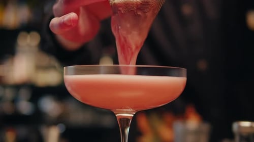 Bartender Make a Cocktail for Guest in the Bar Pink Foamy Sour Alcohol Drink Barman is Doing Drinks